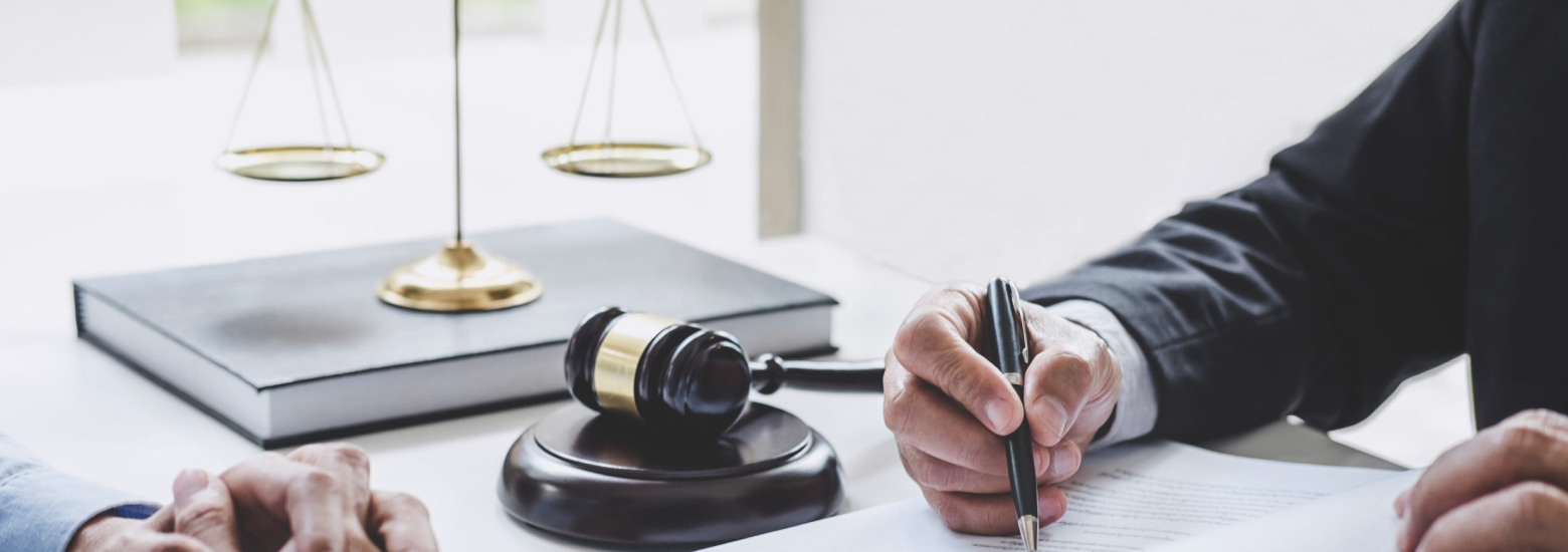 Judge and a man signing a document