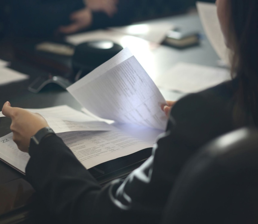 woman looking over legal documents